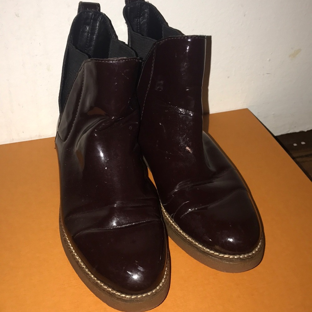Patent leather burgundy ankle boots.